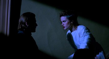 Movie still from “Halloween: The Curse of Michael Myers” (1995), directed by Joe Chappelle – A woman in a white shirt is talking to another woman; Medium shot, Over the shoulder angle