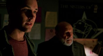 Movie still from “Halloween: The Curse of Michael Myers” (1995), directed by Joe Chappelle – A man and an older man in a dark room; Close Up shot, Over the shoulder angle