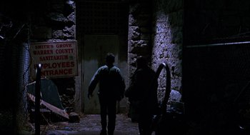 Movie still from “Halloween: The Curse of Michael Myers” (1995), directed by Joe Chappelle – Two people walking down a dark street at night; Wide shot, Low angle