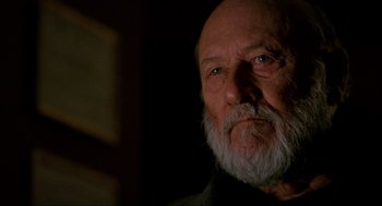 Movie still from “Halloween: The Curse of Michael Myers” (1995), directed by Joe Chappelle – An old man with a beard is looking at the camera; Close Up shot, Low angle