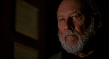 Movie still from “Halloween: The Curse of Michael Myers” (1995), directed by Joe Chappelle – An old man with a beard is looking at the camera; Close Up shot, Low angle
