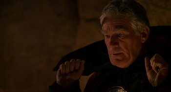 Movie still from “Halloween: The Curse of Michael Myers” (1995), directed by Joe Chappelle – An older man wearing a black cape and holding a black cape; Close Up shot, Low angle