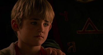 Movie still from “Halloween: The Curse of Michael Myers” (1995), directed by Joe Chappelle – A young boy sitting in front of a wall; Close Up shot, Low angle