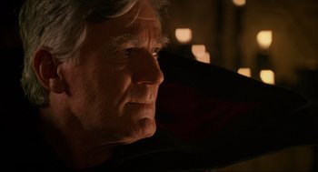 Movie still from “Halloween: The Curse of Michael Myers” (1995), directed by Joe Chappelle – An older man with white hair looking off into the distance; Close Up shot, Over the shoulder angle