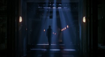 Movie still from “Halloween: The Curse of Michael Myers” (1995), directed by Joe Chappelle – A man is standing in a dark room with lights; Extreme Wide shot, Low angle