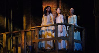 Movie still from “Hamilton” (2020), directed by Thomas Kail – A group of young women standing next to each other on a balcony; Wide shot, High angle