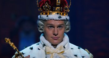 Movie still from “Hamilton” (2020), directed by Thomas Kail – A person wearing a crown; Close Up shot, High angle