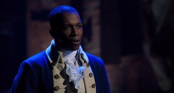 Movie still from “Hamilton” (2020), directed by Thomas Kail – A man in a blue jacket and a white and blue shirt; Close Up shot, Over the shoulder angle