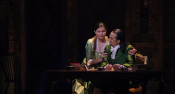 Movie still from “Hamilton” (2020), directed by Thomas Kail – Two people sitting at a table in front of a candle; Medium shot, Over the shoulder angle