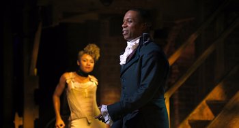 Movie still from “Hamilton” (2020), directed by Thomas Kail – A man and a woman are performing in a musical; Medium shot, Over the shoulder angle