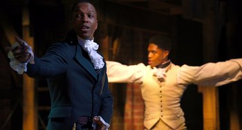 Movie still from “Hamilton” (2020), directed by Thomas Kail – Two men are dressed in period clothing; Medium shot, Over the shoulder angle