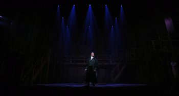Movie still from “Hamilton” (2020), directed by Thomas Kail – A man standing on a stage in front of a bunch of spotlights; Extreme Wide shot, Low angle