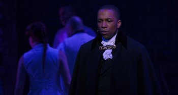 Movie still from “Hamilton” (2020), directed by Thomas Kail – A man in a black jacket and a white bow tie; Close Up shot, Over the shoulder angle