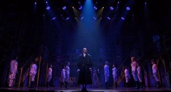 Movie still from “Hamilton” (2020), directed by Thomas Kail – A group of people in a room with lights on them; Extreme Wide shot, Low angle