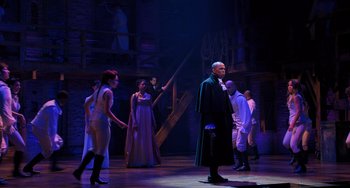 Movie still from “Hamilton” (2020), directed by Thomas Kail – A group of people standing on top of a stage; Wide shot, Over the shoulder angle