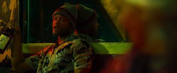 Movie still from “Hancock” (2008), directed by Peter Berg – A man with a hat is standing next to another man with a hat; Close Up shot, Over the shoulder angle