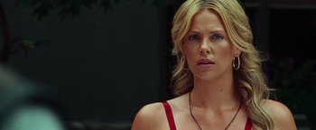 Movie still from “Hancock” (2008), directed by Peter Berg – A person with blond hair wearing a red top; Close Up shot, Over the shoulder angle