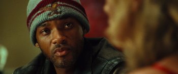 Movie still from “Hancock” (2008), directed by Peter Berg – A person wearing a hat; Close Up shot, Over the shoulder angle