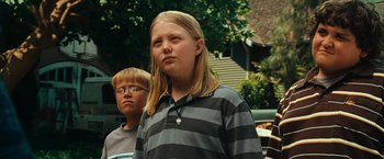 Movie still from “Hancock” (2008), directed by Peter Berg – A boy and a girl standing next to each other; Close Up shot, Low angle