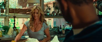 Movie still from “Hancock” (2008), directed by Peter Berg – A woman sitting at a table in front of a man; Medium shot, Over the shoulder angle