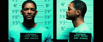 Movie still from “Hancock” (2008), directed by Peter Berg – A person in front of a wall; Close Up shot, Low angle