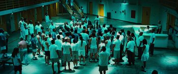 Movie still from “Hancock” (2008), directed by Peter Berg – A large group of people gathered together in a building; Extreme Wide shot, High angle