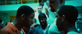 Movie still from “Hancock” (2008), directed by Peter Berg – A group of men standing next to each other in a room; Close Up shot, Over the shoulder angle