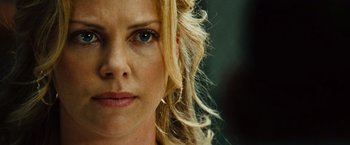 Movie still from “Hancock” (2008), directed by Peter Berg – A woman's face with long blonde hair; Close Up shot, Over the shoulder angle