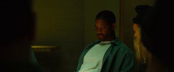 Movie still from “Hancock” (2008), directed by Peter Berg – A man sitting in a chair in the dark; Close Up shot, High angle