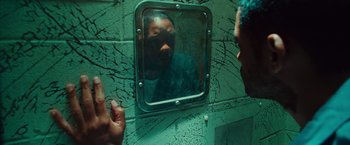Movie still from “Hancock” (2008), directed by Peter Berg – A man looking into a mirror in a bathroom; Close Up shot, Over the shoulder angle