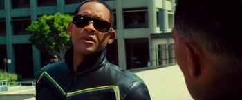 Movie still from “Hancock” (2008), directed by Peter Berg – A person wearing sunglasses and a jacket; Close Up shot, Low angle