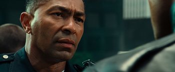 Movie still from “Hancock” (2008), directed by Peter Berg – A man's face in a dark room; Close Up shot, Low angle