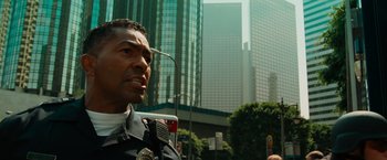 Movie still from “Hancock” (2008), directed by Peter Berg – A police officer talking to a crowd of onlookers; Close Up shot, Low angle