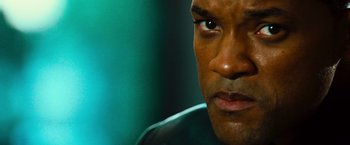 Movie still from “Hancock” (2008), directed by Peter Berg – A man's face with a green background; Close Up shot, Over the shoulder angle