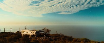 Movie still from “Hancock” (2008), directed by Peter Berg – A group of people standing on top of a hill; Extreme Wide shot, Low angle