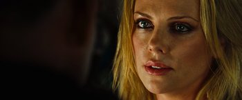Movie still from “Hancock” (2008), directed by Peter Berg – A woman's face with a dark background; Close Up shot, Over the shoulder angle