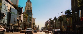 Movie still from “Hancock” (2008), directed by Peter Berg – A city street filled with lots of traffic and palm trees on both sides of the street; Extreme Wide shot, Low angle