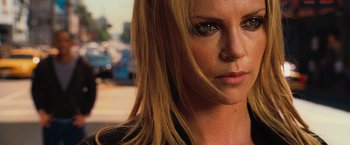Movie still from “Hancock” (2008), directed by Peter Berg – A woman's face with long blonde hair; Close Up shot, Over the shoulder angle