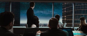 Movie still from “Hancock” (2008), directed by Peter Berg – A group of people sitting in front of a large window; Wide shot, Over the shoulder angle