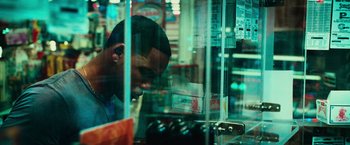 Movie still from “Hancock” (2008), directed by Peter Berg – A man looking through a glass case in a grocery store; Close Up shot, Over the shoulder angle
