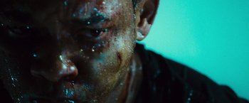Movie still from “Hancock” (2008), directed by Peter Berg – A man's face with a lot of dirt on his face; Extreme Close Up shot, Low angle