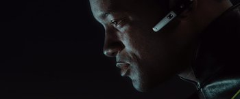 Movie still from “Hancock” (2008), directed by Peter Berg – A person with a cell phone in his ear; Close Up shot, Over the shoulder angle