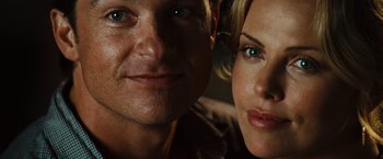 Movie still from “Hancock” (2008), directed by Peter Berg – A man and a woman posing for a picture; Close Up shot, Overhead angle
