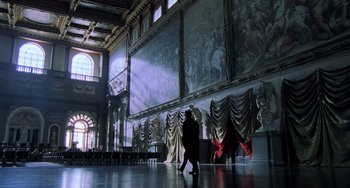 Movie still from “Hannibal” (2001), directed by Ridley Scott – A person walking in a room with a large painting on the wall; Extreme Wide shot, Low angle