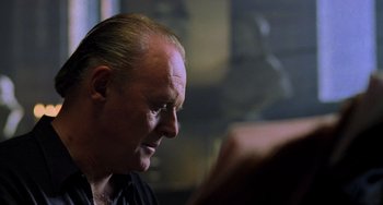 Movie still from “Hannibal” (2001), directed by Ridley Scott – A person looking down at a book; Close Up shot, Low angle