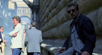 Movie still from “Hannibal” (2001), directed by Ridley Scott – A group of people walking down a sidewalk; Medium shot, Over the shoulder angle