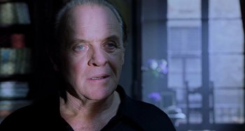 Movie still from “Hannibal” (2001), directed by Ridley Scott – An older man is looking at the camera; Close Up shot, Low angle