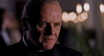 Movie still from “Hannibal” (2001), directed by Ridley Scott – A person wearing a suit and tie; Close Up shot, Low angle