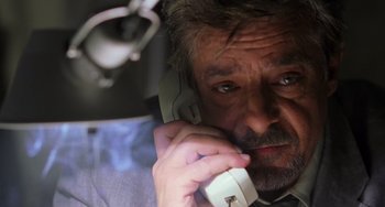 Movie still from “Hannibal” (2001), directed by Ridley Scott – A person talking on a cell phone; Close Up shot, Low angle