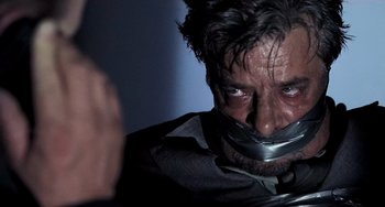 Movie still from “Hannibal” (2001), directed by Ridley Scott – A person with duct tape on their face; Close Up shot, Over the shoulder angle